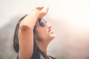 Outdoor summer portrait of young girl in black goggles suffering sun heat